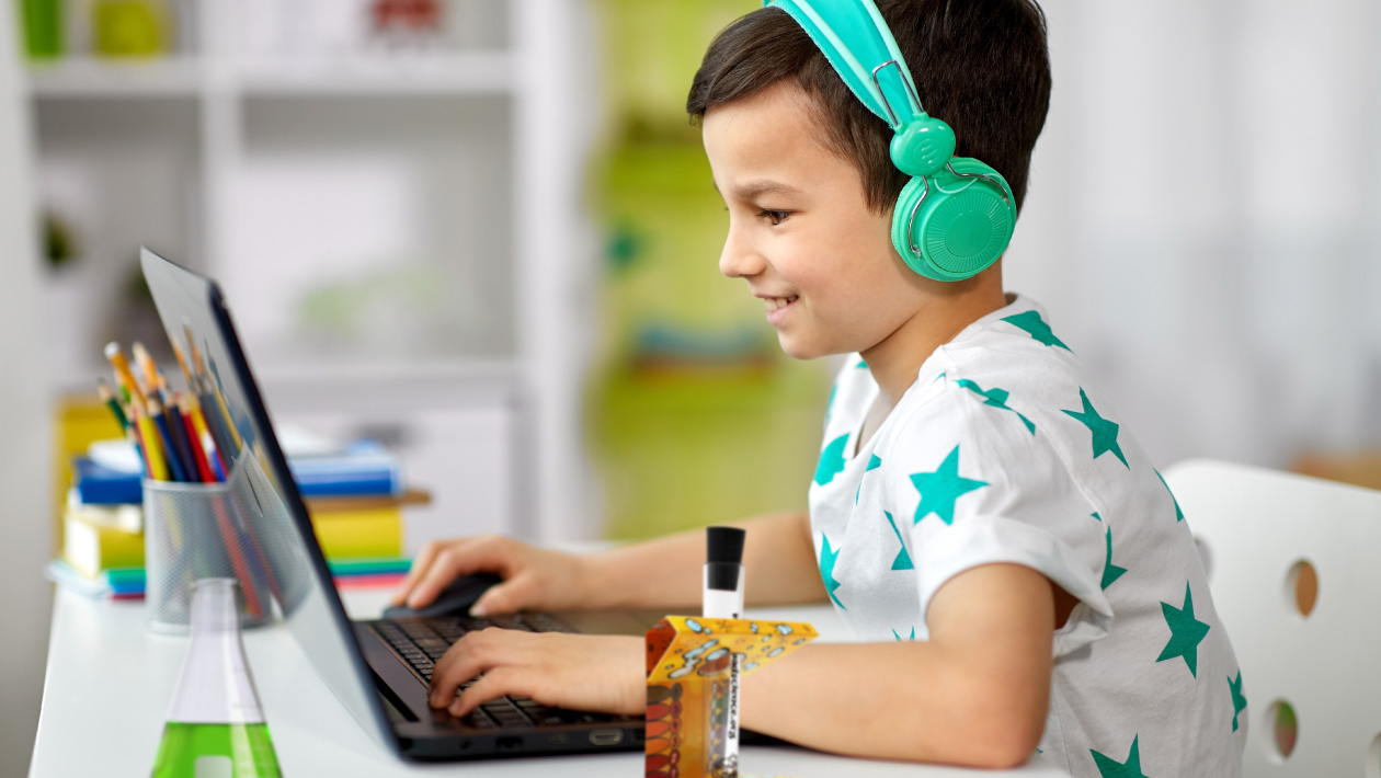 Boy performing a Mad Science Virtual class sitting in front of his computer
